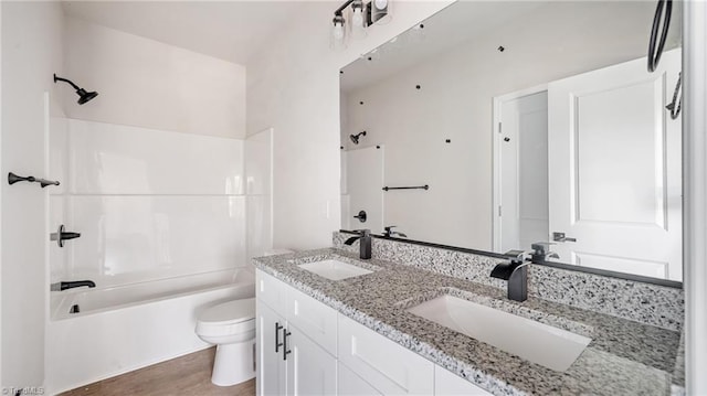 full bathroom with washtub / shower combination, wood-type flooring, vanity, and toilet