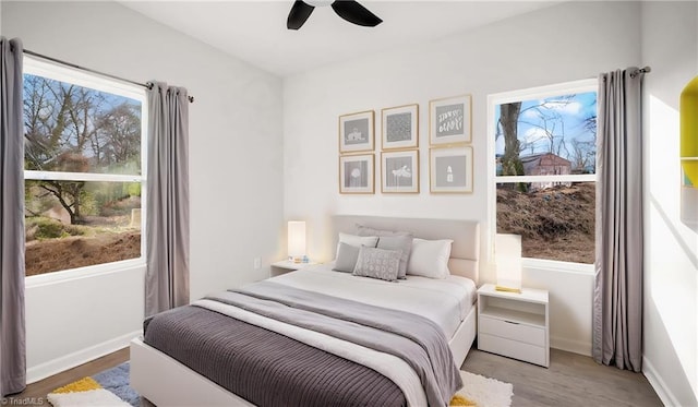 bedroom with hardwood / wood-style floors and ceiling fan