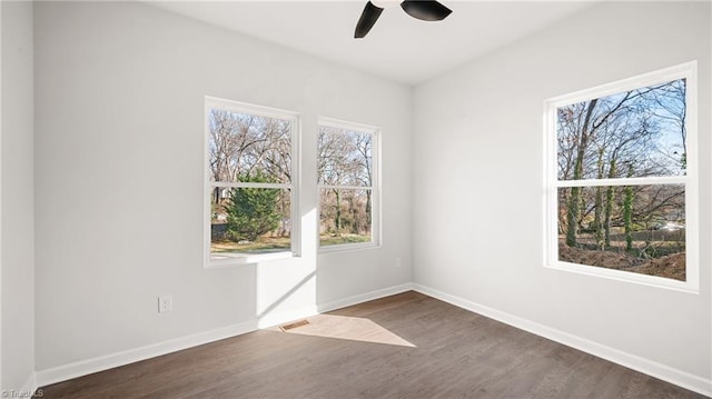 unfurnished room featuring dark hardwood / wood-style flooring and ceiling fan