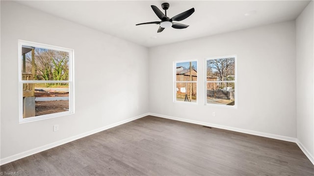 unfurnished room with dark hardwood / wood-style flooring and ceiling fan