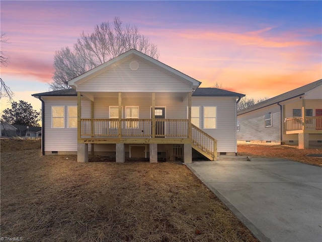 back house at dusk with covered porch