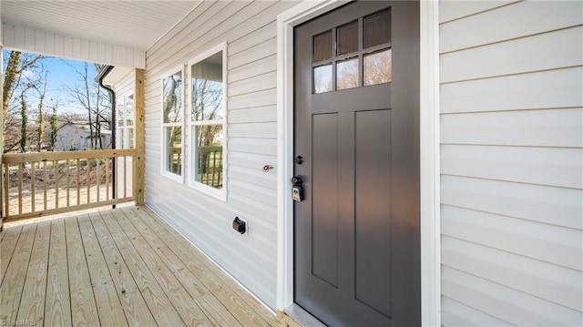 view of exterior entry with covered porch