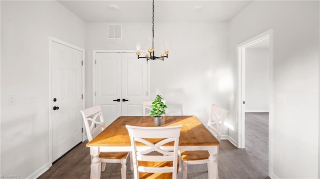 dining space with a chandelier and dark hardwood / wood-style flooring