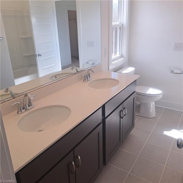 full bath featuring tile patterned floors, toilet, and a sink