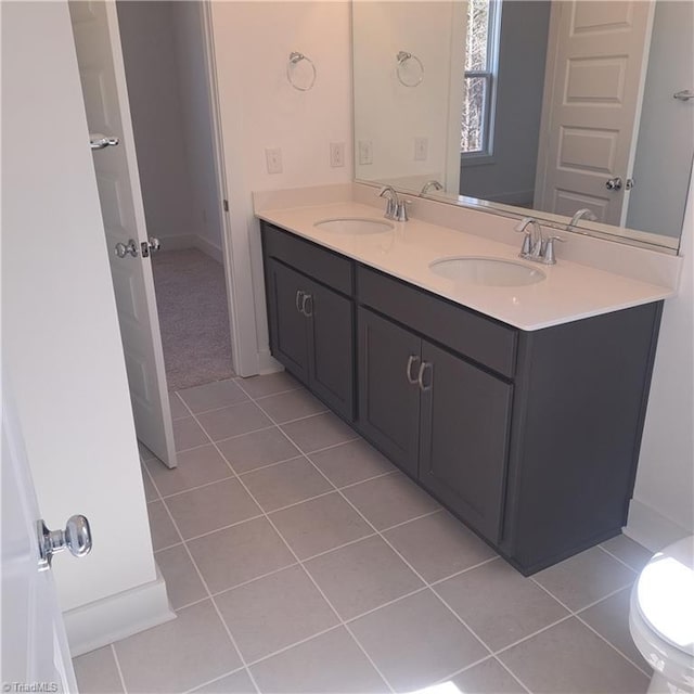 bathroom with tile patterned flooring, double vanity, and a sink