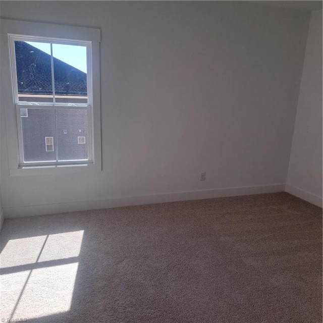 empty room with carpet flooring and baseboards