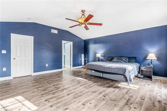 bedroom featuring lofted ceiling, light hardwood / wood-style floors, and ceiling fan