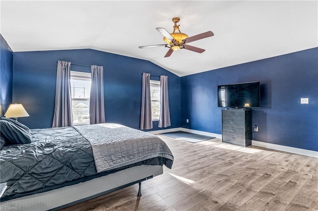 bedroom featuring ceiling fan, lofted ceiling, and wood-type flooring