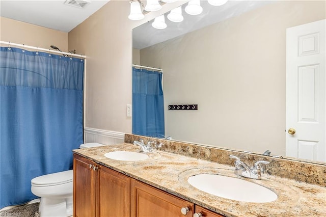 bathroom with a shower with curtain, vanity, and toilet