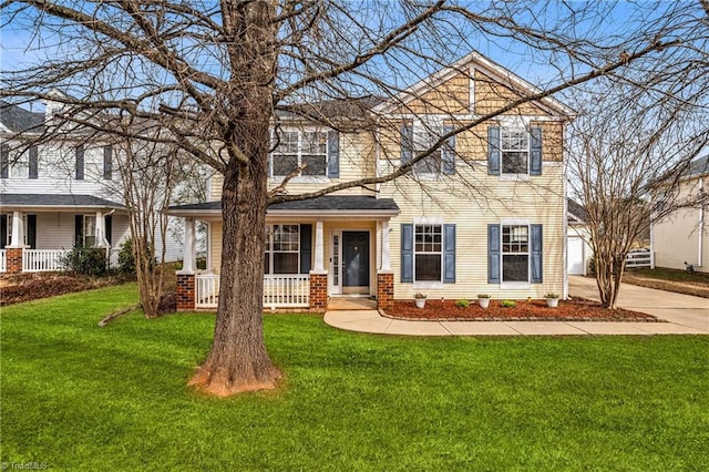 view of front of home with a porch and a front yard