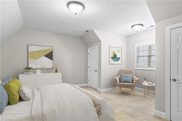 bedroom featuring lofted ceiling and light carpet