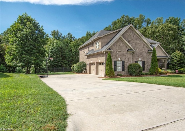 view of front of property with a garage and a front lawn