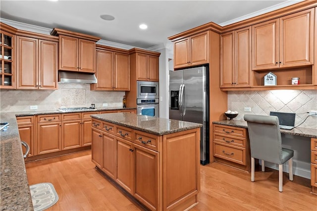 kitchen featuring tasteful backsplash, crown molding, light hardwood / wood-style flooring, dark stone counters, and stainless steel appliances