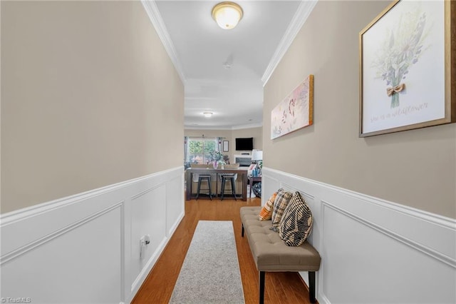 3502 Quarry Ct, High Point, NC 27265 - hall with crown molding, a wainscoted wall, wood finished floors, and a decorative wall