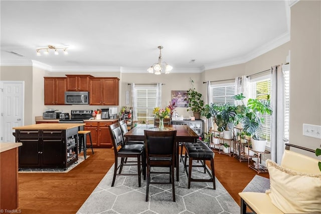3502 Quarry Ct, High Point, NC 27265 - dining space with a chandelier, wood finished floors, and crown molding