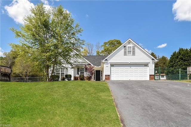 view of front of property with a front yard and a garage