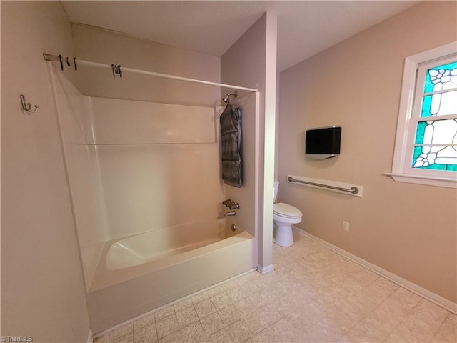 bathroom featuring shower / bath combination and toilet