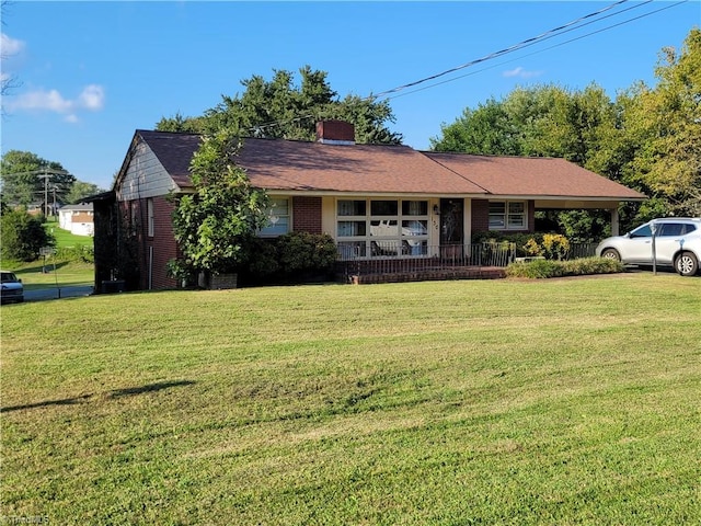 ranch-style house featuring a front lawn and covered porch