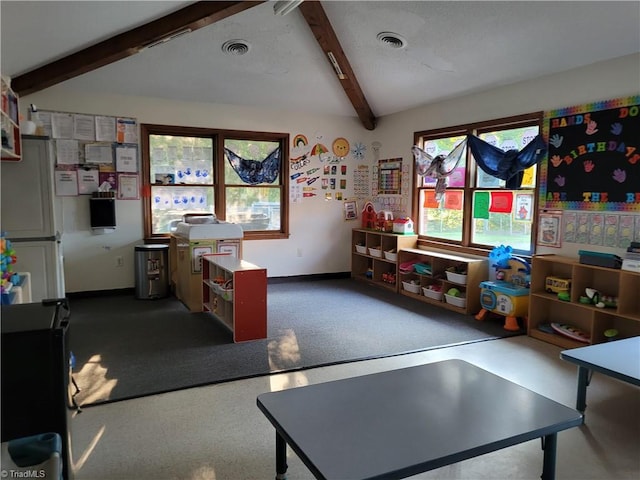 recreation room with lofted ceiling with beams