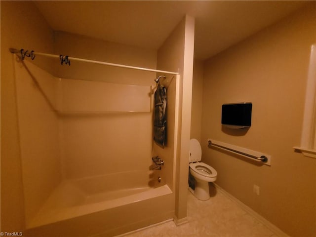 bathroom featuring shower / tub combination and toilet