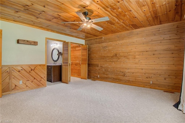 4962 Serenity Ln, Granite Falls, NC 28630 - unfurnished room with wood walls, a ceiling fan, wooden ceiling, light colored carpet, and a wainscoted wall