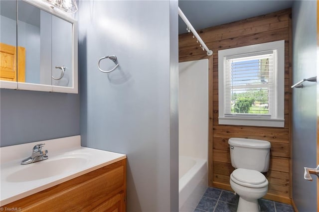 4962 Serenity Ln, Granite Falls, NC 28630 - bathroom featuring toilet, vanity, wood walls, tile patterned flooring, and  shower combination