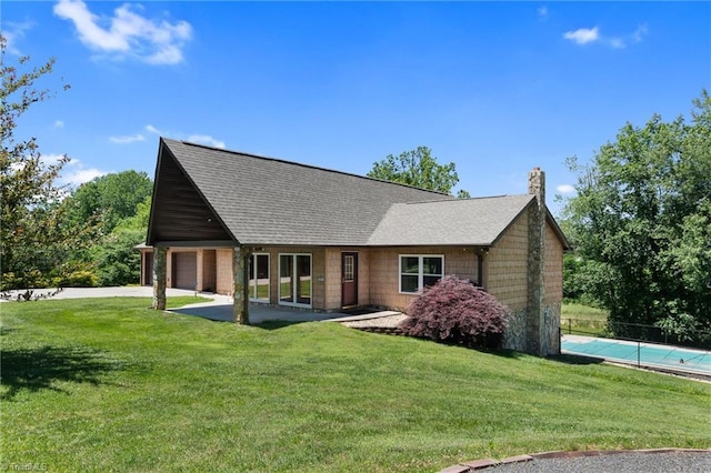 4962 Serenity Ln, Granite Falls, NC 28630 - view of front facade with a chimney, driveway, an attached garage, and a shingled roof