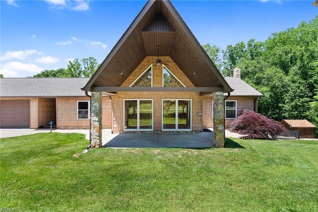 4962 Serenity Ln, Granite Falls, NC 28630 - back of property featuring a lawn, an attached garage, a chimney, a patio area, and stone siding