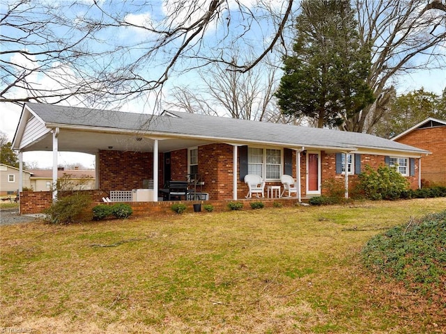 single story home with a front lawn, a porch, a carport, and brick siding