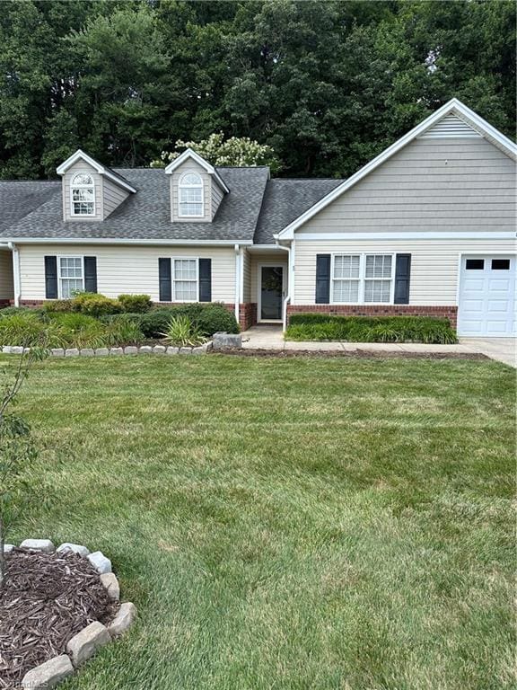 135 Plantation Place Ln, Mount Airy, NC 27030 - view of front facade with a front lawn, a shingled roof, brick siding, and an attached garage