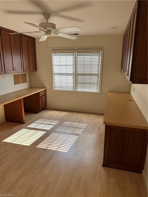 135 Plantation Place Ln, Mount Airy, NC 27030 - unfurnished dining area featuring ceiling fan, light wood-style floors, and built in desk
