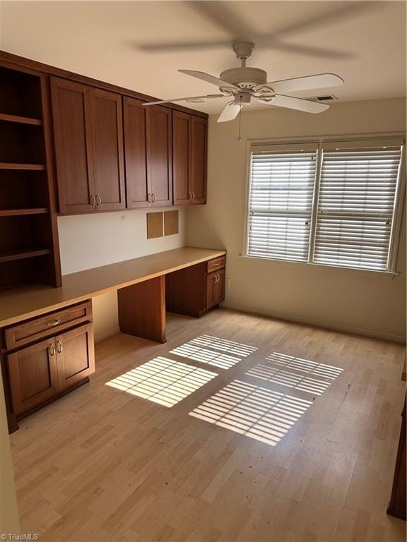 135 Plantation Place Ln, Mount Airy, NC 27030 - unfurnished office featuring built in desk, ceiling fan, and light wood-style flooring