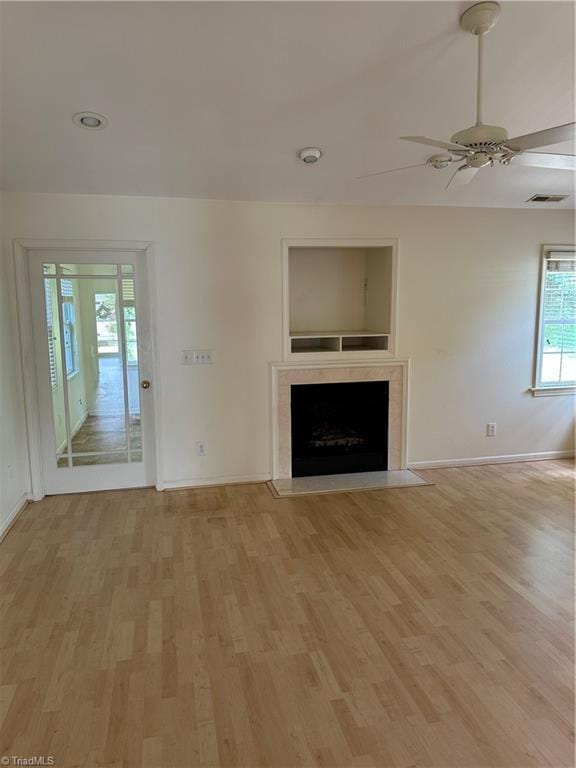 135 Plantation Place Ln, Mount Airy, NC 27030 - unfurnished living room featuring light wood-type flooring, a ceiling fan, and a fireplace