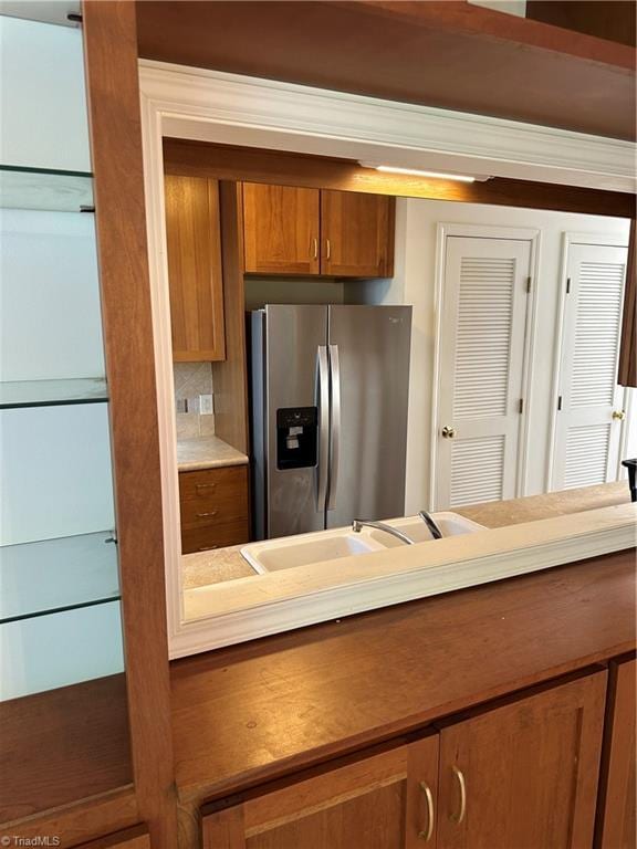 135 Plantation Place Ln, Mount Airy, NC 27030 - kitchen featuring stainless steel fridge with ice dispenser, brown cabinetry, backsplash, and light countertops