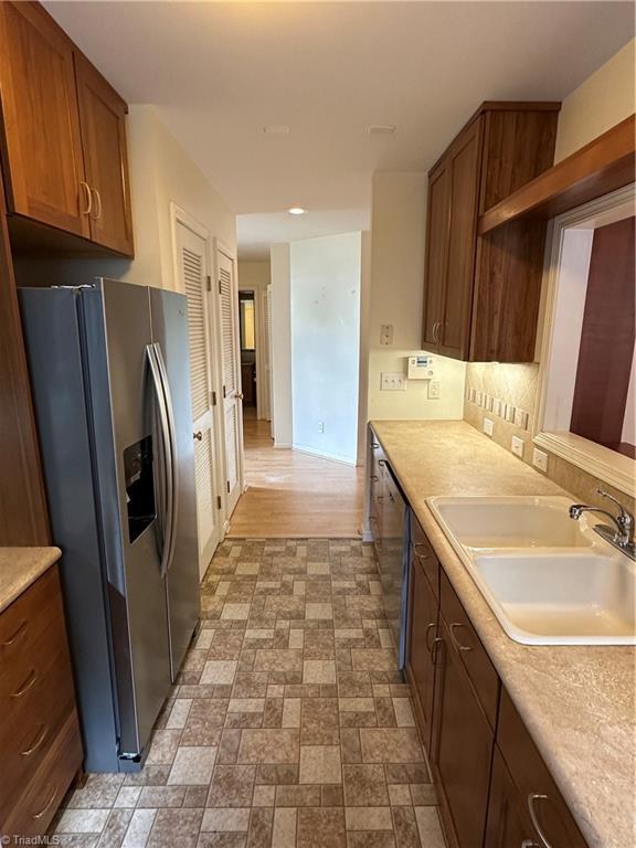 135 Plantation Place Ln, Mount Airy, NC 27030 - kitchen with appliances with stainless steel finishes, light countertops, brown cabinets, and recessed lighting