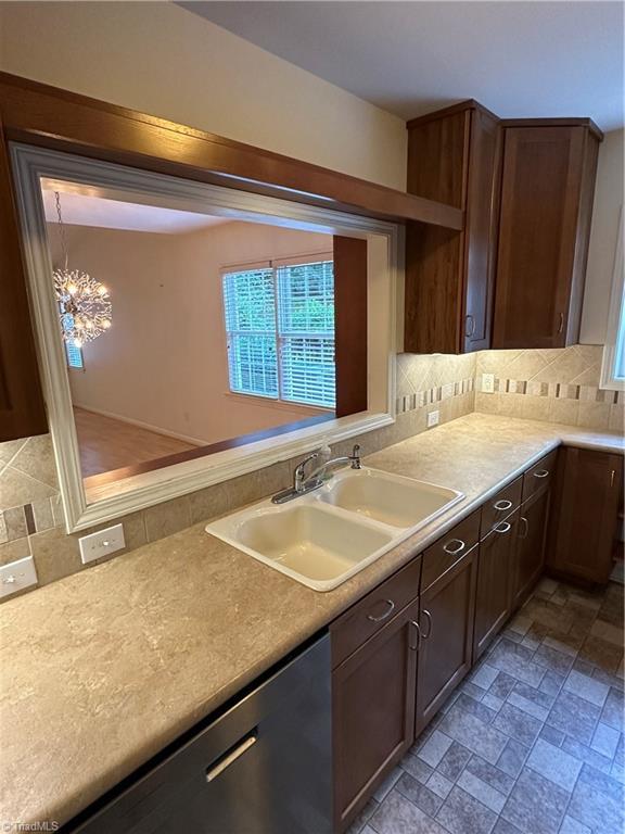 135 Plantation Place Ln, Mount Airy, NC 27030 - kitchen featuring backsplash, dishwasher, light countertops, and healthy amount of natural light