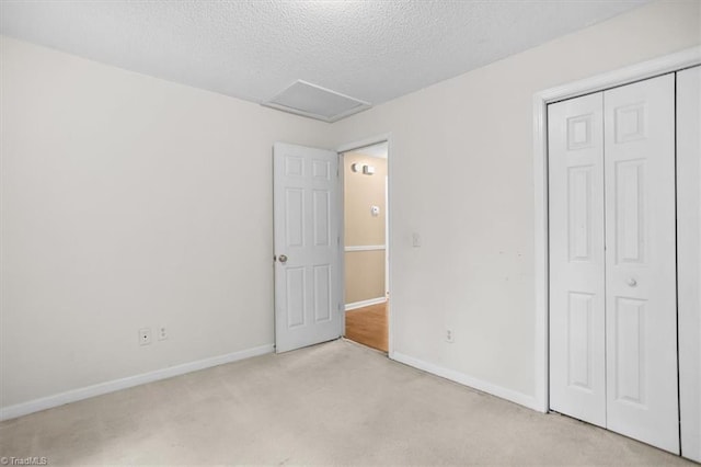 816 W Brook Ct, Archdale, NC 27263 - unfurnished bedroom featuring light carpet, a closet, attic access, and a textured ceiling