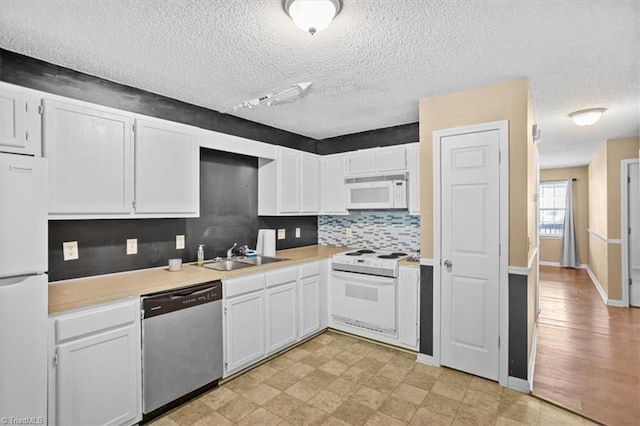 816 W Brook Ct, Archdale, NC 27263 - kitchen with white appliances, white cabinets, light countertops, backsplash, and a textured ceiling