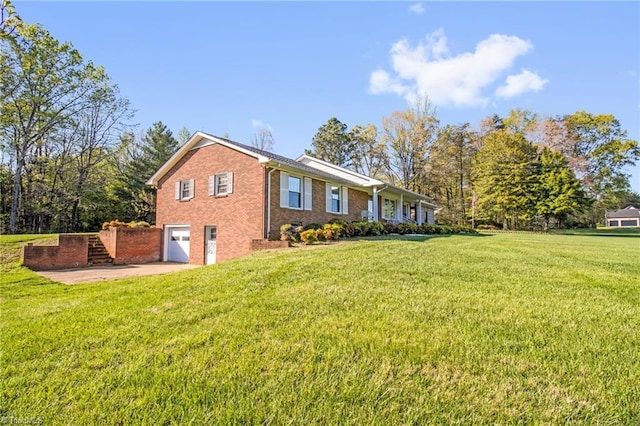 520 S Bunker Hill Rd, Colfax, NC 27235 - view of home's exterior with a garage, brick siding, a lawn, and concrete driveway