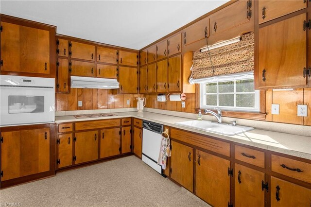 520 S Bunker Hill Rd, Colfax, NC 27235 - kitchen with white appliances, under cabinet range hood, light countertops, and brown cabinets