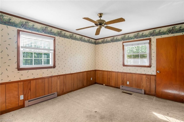 520 S Bunker Hill Rd, Colfax, NC 27235 - unfurnished room with a baseboard heating unit, a wainscoted wall, wallpapered walls, a ceiling fan, and light carpet