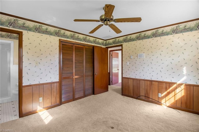 520 S Bunker Hill Rd, Colfax, NC 27235 - unfurnished bedroom featuring wallpapered walls, a wainscoted wall, carpet, a closet, and crown molding