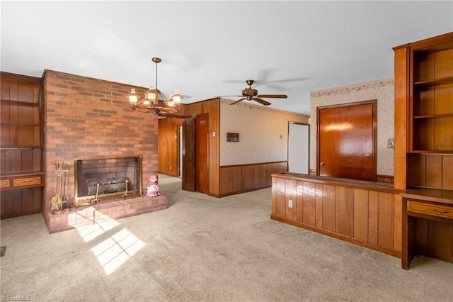 520 S Bunker Hill Rd, Colfax, NC 27235 - unfurnished living room with wallpapered walls, wainscoting, carpet, a ceiling fan, and wood walls