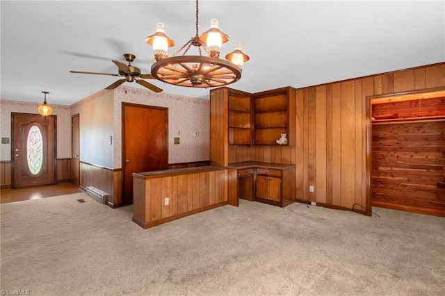 520 S Bunker Hill Rd, Colfax, NC 27235 - unfurnished dining area featuring wallpapered walls, light colored carpet, wooden walls, a ceiling fan, and a chandelier