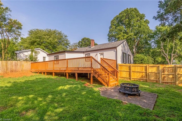 1908 Hilldale Dr, Burlington, NC 27215 - back of property with an outdoor fire pit, a deck, a fenced backyard, and a chimney