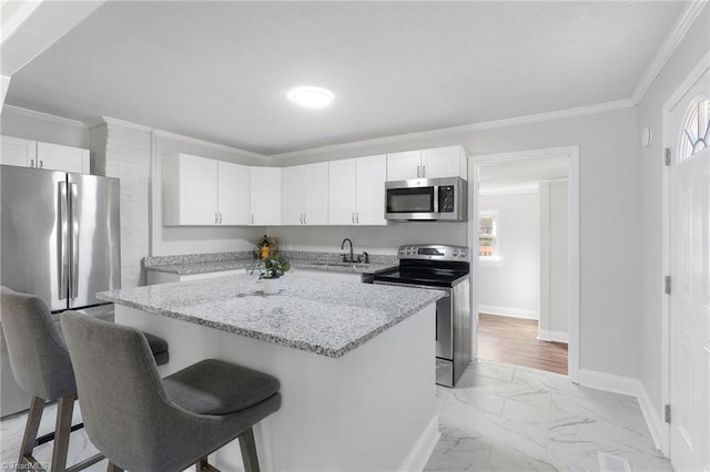 1908 Hilldale Dr, Burlington, NC 27215 - kitchen with appliances with stainless steel finishes, light marble finish flooring, white cabinetry, a breakfast bar area, and crown molding