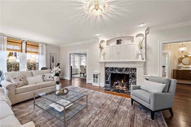 living room featuring crown molding, baseboards, dark wood-type flooring, and a high end fireplace