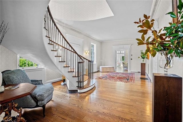 entryway featuring wood-type flooring and crown molding