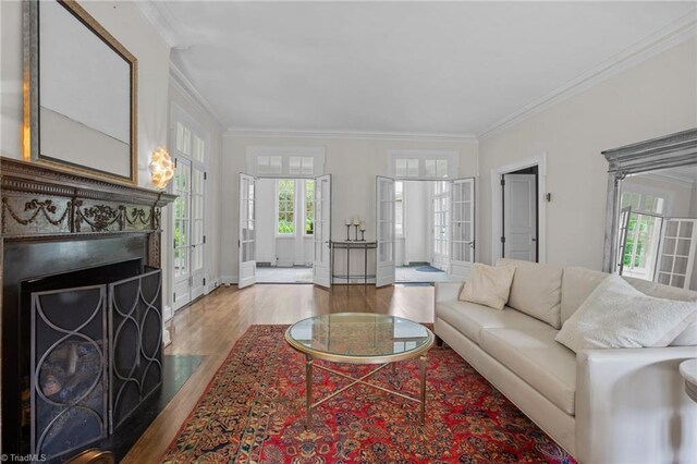 living room with crown molding and hardwood / wood-style floors