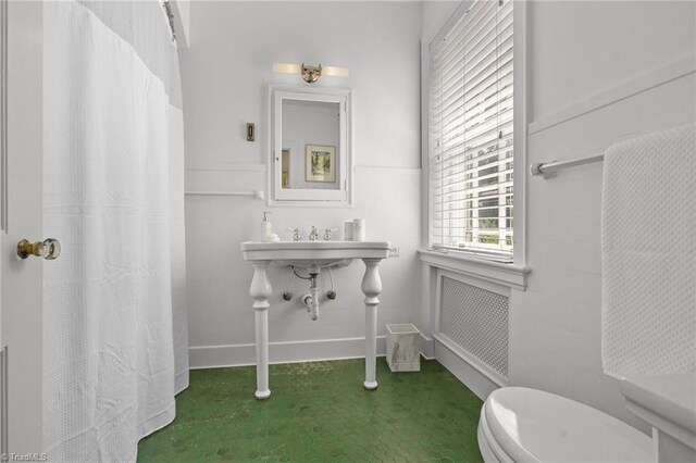 bathroom featuring toilet and radiator heating unit